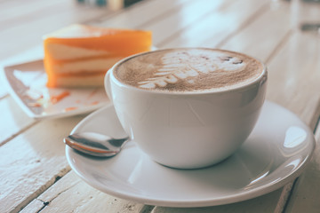 Coffee and orange cake on wooden table, Soft focus, Vintage tone