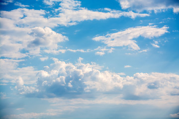 White curly clouds in a blue sky. Sky background