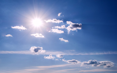 White curly clouds in a blue sky. Sky background