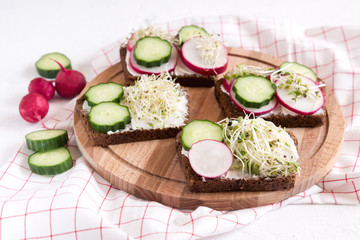 Tasty healthy sandwich Rye sandwich with radish cucumber Copy space Healthy breakfast