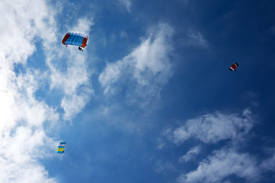 three paraplanes in blue sky