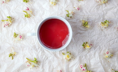 Cup of tea and chestnut blossom flowers
