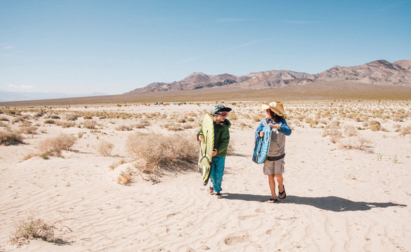 Two boys walking together Eureka Dunes, Death Valley National Park, California, USA