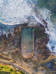 Aerial view of Cronulla tidal bath with incoming waves