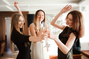 Group people with champagne dancing at the party.