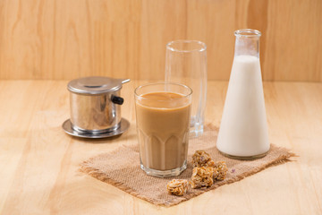Coffee with milk on a wooden table.