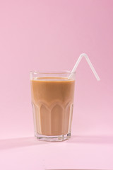 Coffee with milk on a pink background.