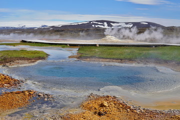 Hot steam coming from the boiling water in the central Iceland in the geothermal area of Hveravellir as a symbol of powerful geothermal green energ