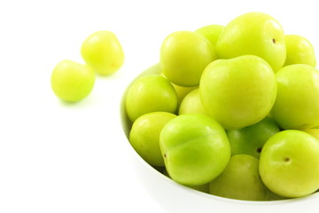 fresh turkish can erik plum fruits in a small white bowl