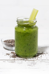 healthy green fruit and vegetable smoothies with chia seeds on white table