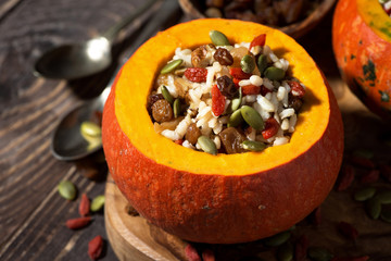 rice with dried fruit in a pumpkin, closeup
