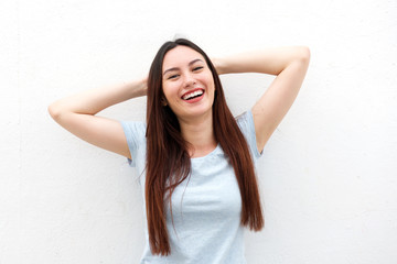 Happy young woman with hands by head in relaxation