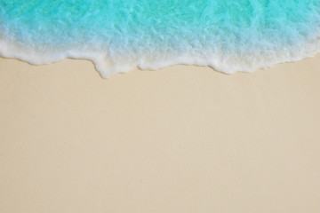 Naklejka na ściany i meble Soft waves of blue sea on the Maldives beach for the background.