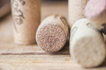 Blue grapes lie on a wooden background. Grapes macro. Grapes with droplets of water. Grapes in a cut. Grapes and wine corks. Blue and green grapes