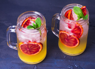 Cocktail with orange, garnished with mint