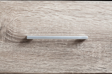 Silver handle in a drawer
