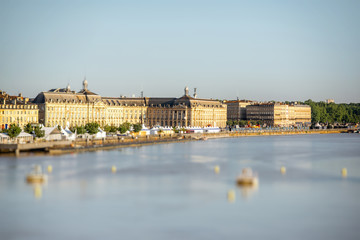 View on Garonne river and riverside with La Bourse square in Bordeaux city, France. Image with tilt-shift technic