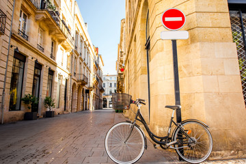 Street view with bicycle and road sign at the old town of Bordeaux city, France - obrazy, fototapety, plakaty