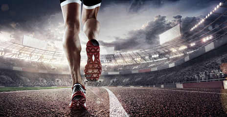 Fototapeta na wymiar Sports background. Runner feet running on stadium closeup on shoe. Dramatic picture.
