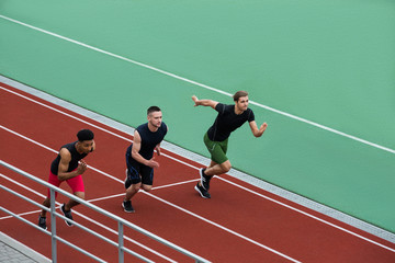 Fototapeta premium Concentrated multiethnic athlete group run