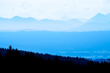 Spectacular view of mountain ranges silhouettes in blue twilight hour