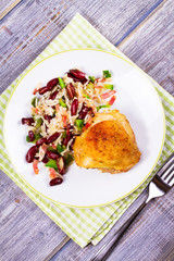 Chicken with Rice, Beans, Bacon and Green Pepper on White Plate. View from above, top studio shot