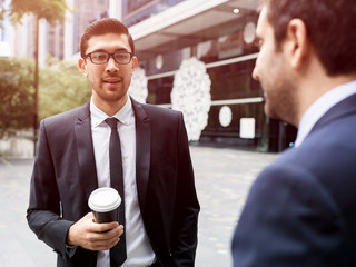 Two businessmen talking outdoors