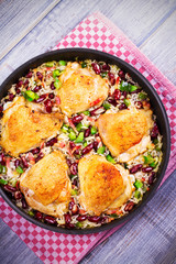 Chicken with Rice, Beans, Bacon and Green Pepper in Pan. View from above, top studio shot