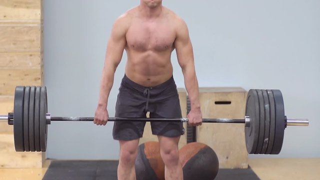 Young Male Athlete Trains With A Barbell In The Gym. Slow motion