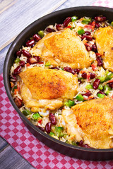 Chicken with Rice, Beans, Bacon and Green Pepper in Pan. View from above, top studio shot