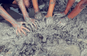 Close up, Asian boys' hands cling to mud, they would use clay in the field to mold the stuff. Ground structure is rich in various minerals.