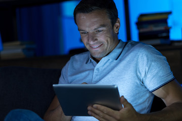 Fototapeta premium Enthusiastic passionate man reading something online
