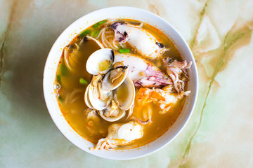 Seafood Tom Yam, Thai soup  in white bowl