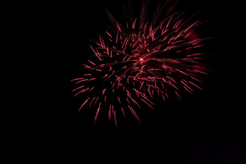 Bursting fireworks against black background