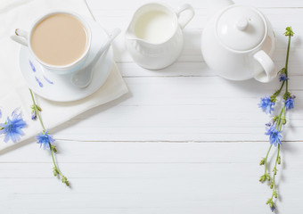 Drink from chicory in a cup on the white wooden table