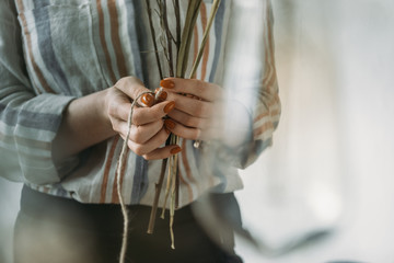 cropped view of female hands with dry flowers at workplace