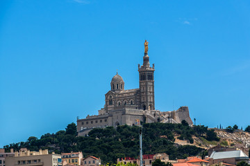 Fototapeta na wymiar Neo-Byzantine Basilica of Notre-Dame de la Garde (Our Lady of the Guard, architect Henri-Jacques Esperandieu, 1864) in Marseille, is city's best-known symbol. Provence-Alpes-Cote d'Azur, France.