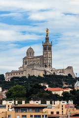 Fototapeta na wymiar Neo-Byzantine Basilica of Notre-Dame de la Garde (Our Lady of the Guard, architect Henri-Jacques Esperandieu, 1864) in Marseille, is city's best-known symbol. Provence-Alpes-Cote d'Azur, France.