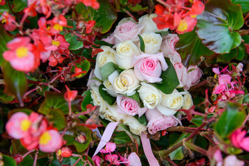 Wedding rings on wedding bouquet in flowers
