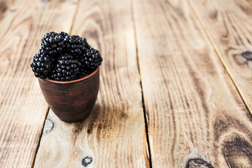 Fototapeta na wymiar ripe blackberries on wooden background
