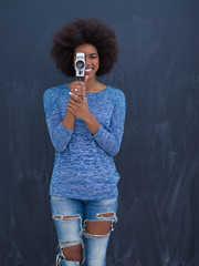 african american woman using a retro video camera