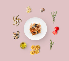 Obraz premium Cooking ingredients for italian food, seafood pasta, isolated on pink