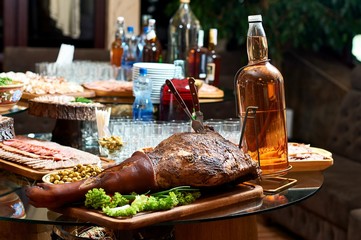Close up of a restaurant table. Smoked pork served on a wooden plate.