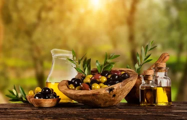 Foto op Plexiglas Freshly harvested olives berries in wood bowls and pressed oil in glass bottles © Jag_cz