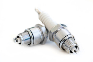 Two spark plugs on white