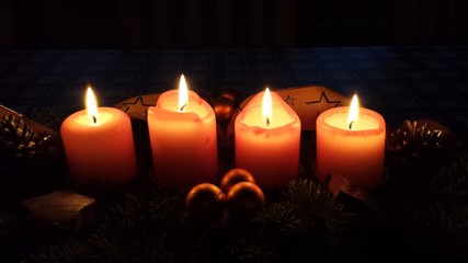 4 Christmas Candles in a dark room