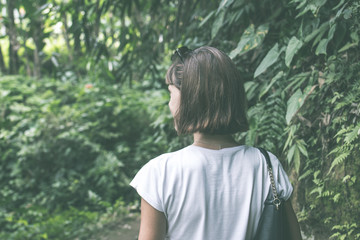 Sexy young brunette beauty woman in a rainforest of Bali island, Indonesia.