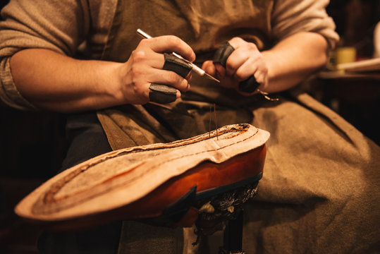 Cropped photo of young man shoemaker