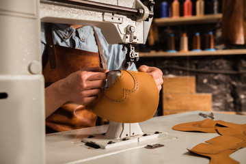 Close up of a shoemaker using sewing machine