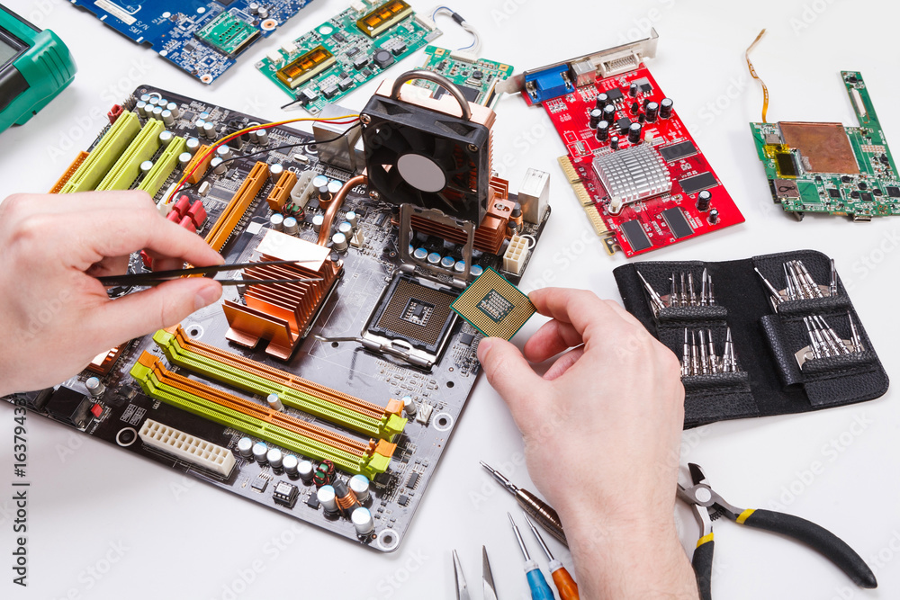 Poster technician plug in microprocessor to motherboard